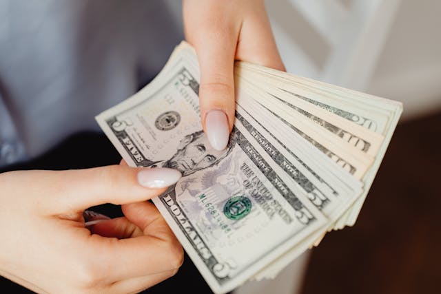 person-counting-paper-money-bills