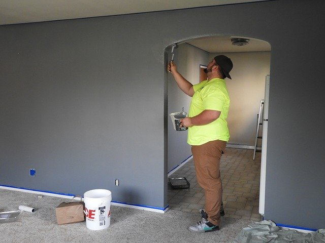 a-contractor-touching-up-paint-on-a-wall.png