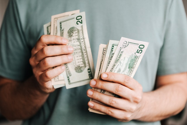 person-in-a-green-shirt-counting-cash.png