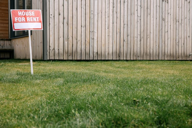 a-for-rent-sign-in-a-front-yard.png