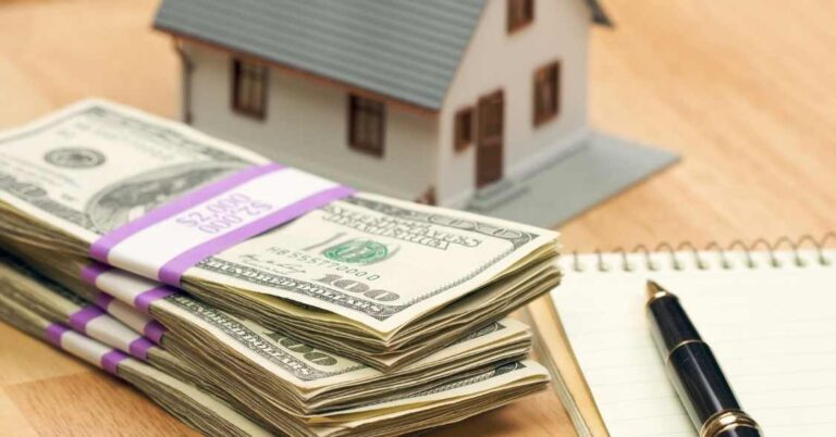 a-stack-of-cash-next-to-a-home-figurine-768x402.png