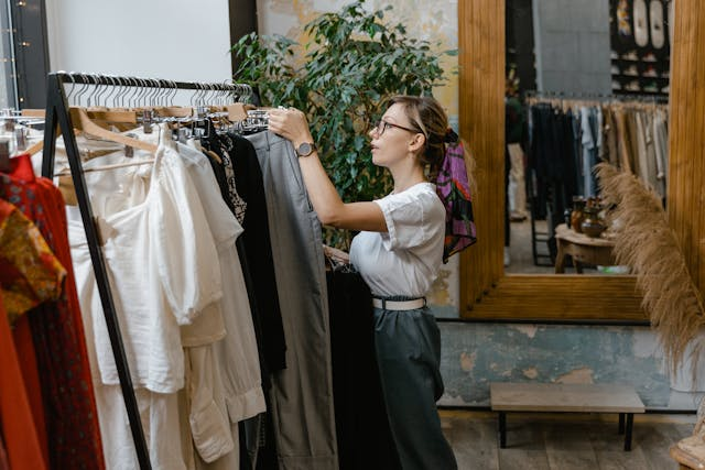 a-worker-organizing-a-clothing-rack-in-a-store.png