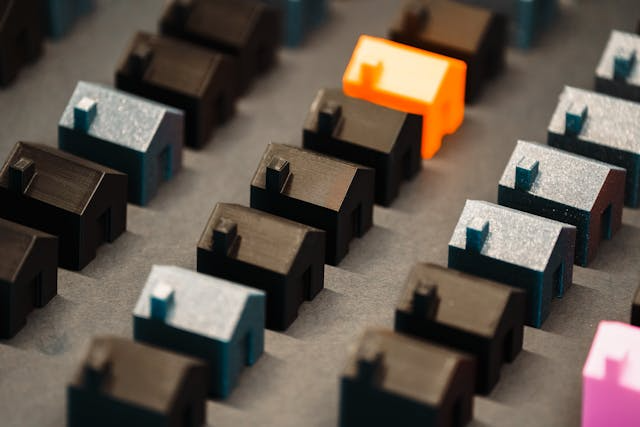 a-bunch-of-house-figurines-in-black-blue-and-orange.png