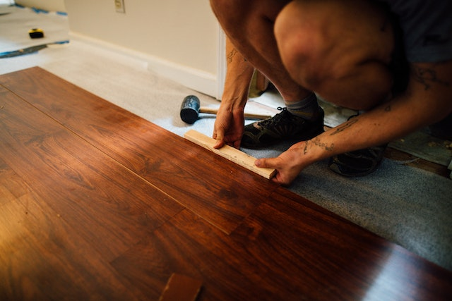 a-home-contractor-installing-dark-wood-flooring.png