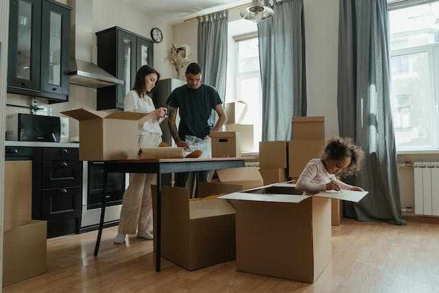 a-couple-and-their-child-unpacking-moving-boxes-in-their-new-kitchen.png