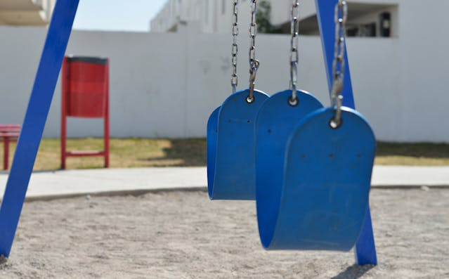 blue-swing-set-at-a-playground.png