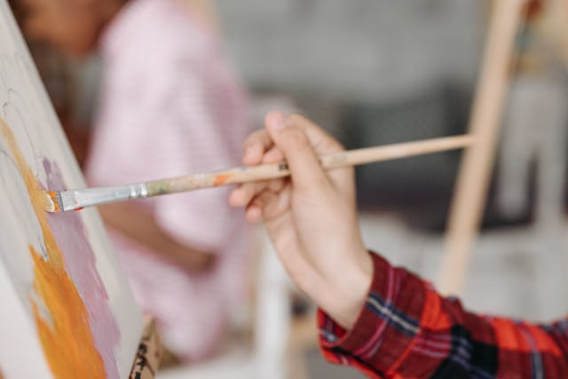 person-painting-on-a-canvas.png